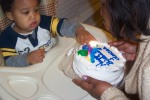 Mommy helping to blow out his candles